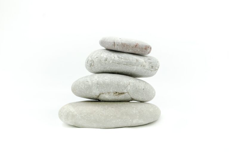 Carefully stacked stones symbolizing rebuilding life stability after disruption
