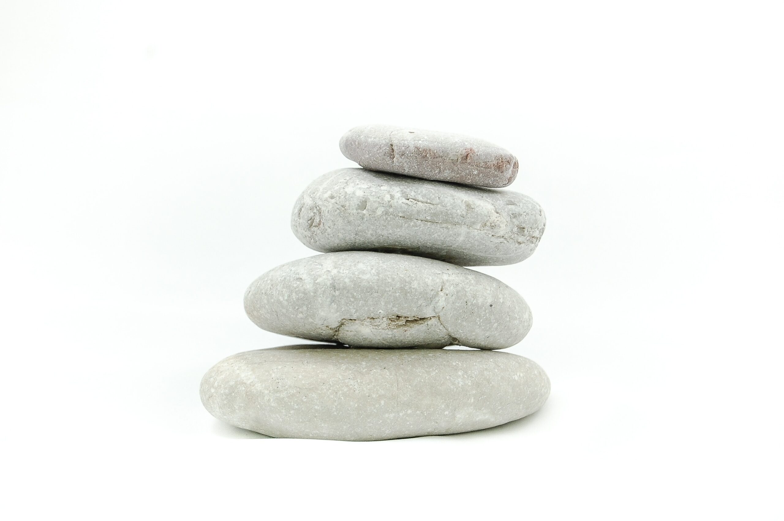 Carefully stacked stones symbolizing rebuilding life stability after disruption